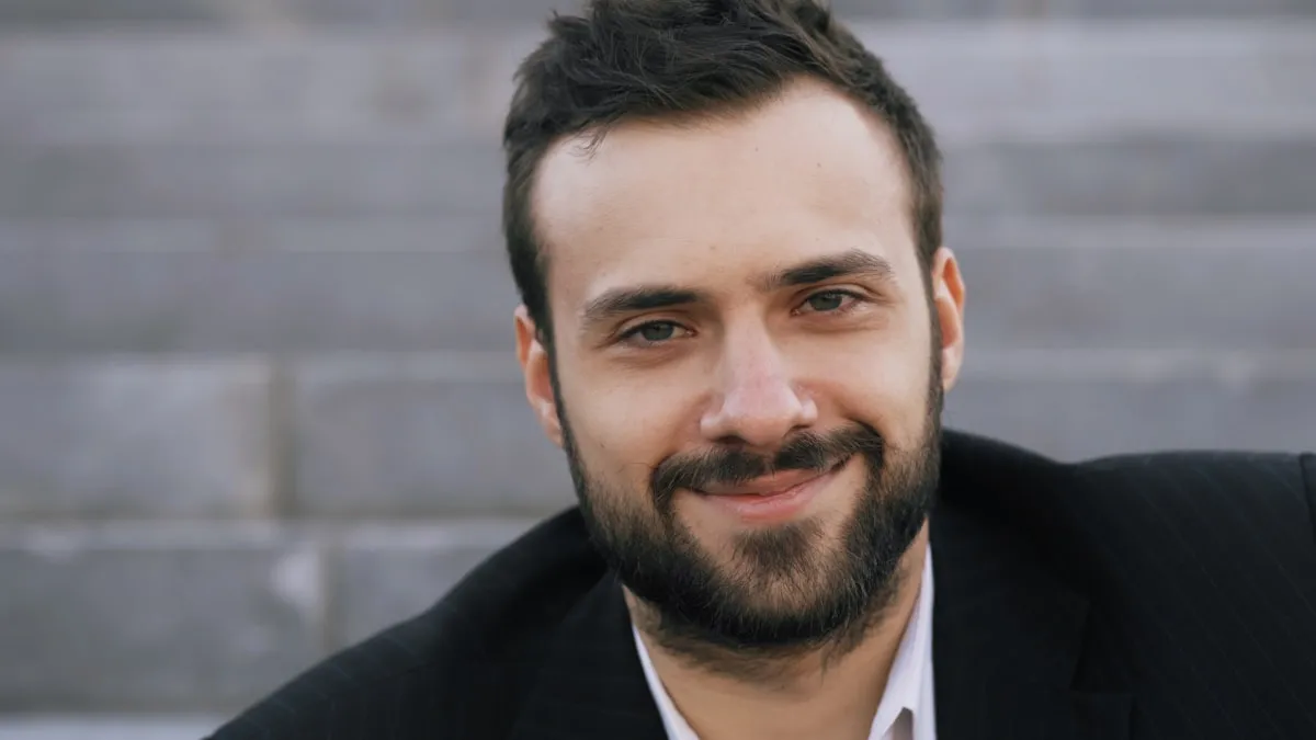 Daniel Reyes, a smiling bearded man, photographed outdoors.
